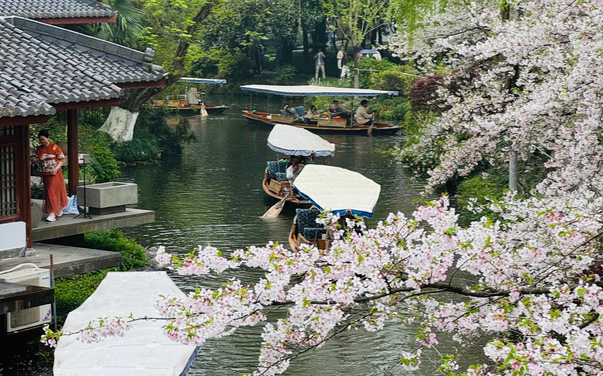 Spring sightseeing boat ride among blooming flowers in Suzhou, China