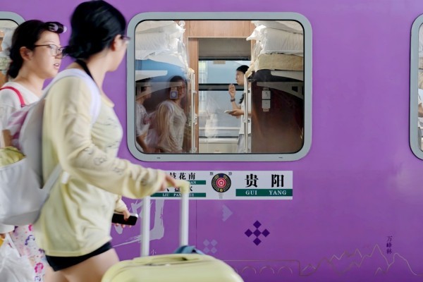 Purple livery train car with panoramic windows