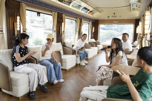 Travelers enjoying the view in the observation car