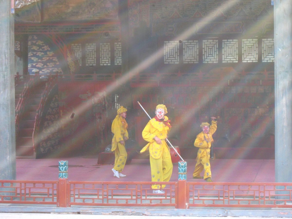 Peking opera performance on a traditional painted stage in China