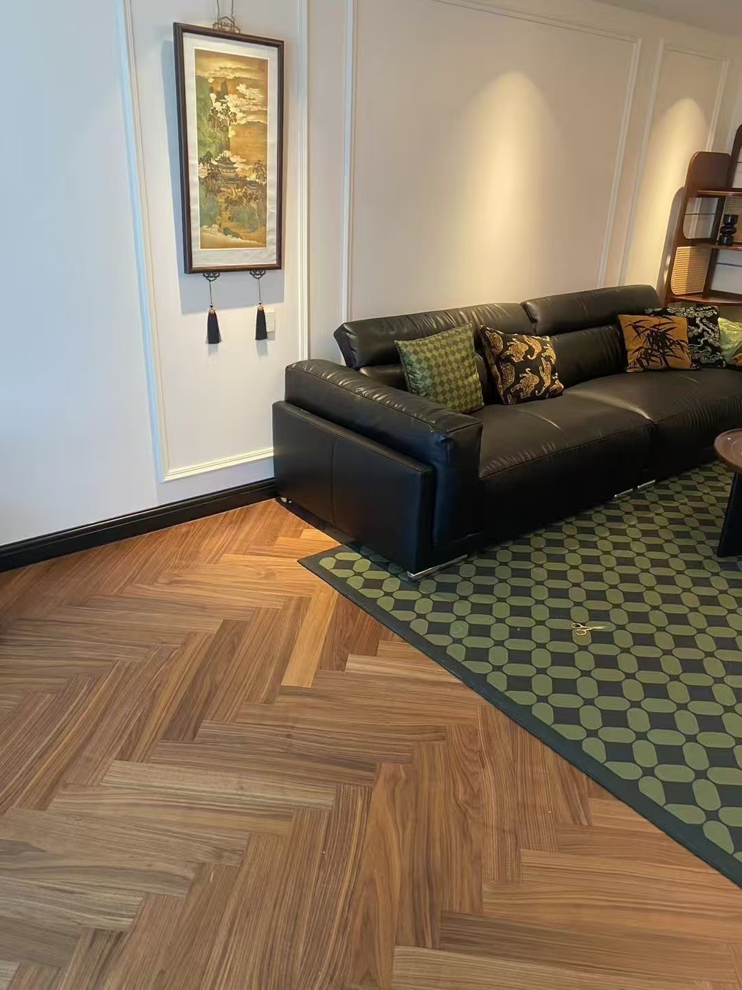 Warm walnut herringbone engineered wood flooring installed in a mid-century modern Amsterdam apartment, featuring elegant oak grain, smooth UV lacquer finish, and retro-inspired interior styling with natural daylight.