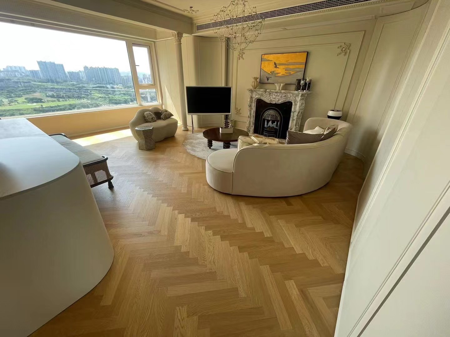 Light natural oak herringbone engineered wood flooring installed in a luxury Sydney Harbour condominium with modern French interior styling and bright natural lighting.