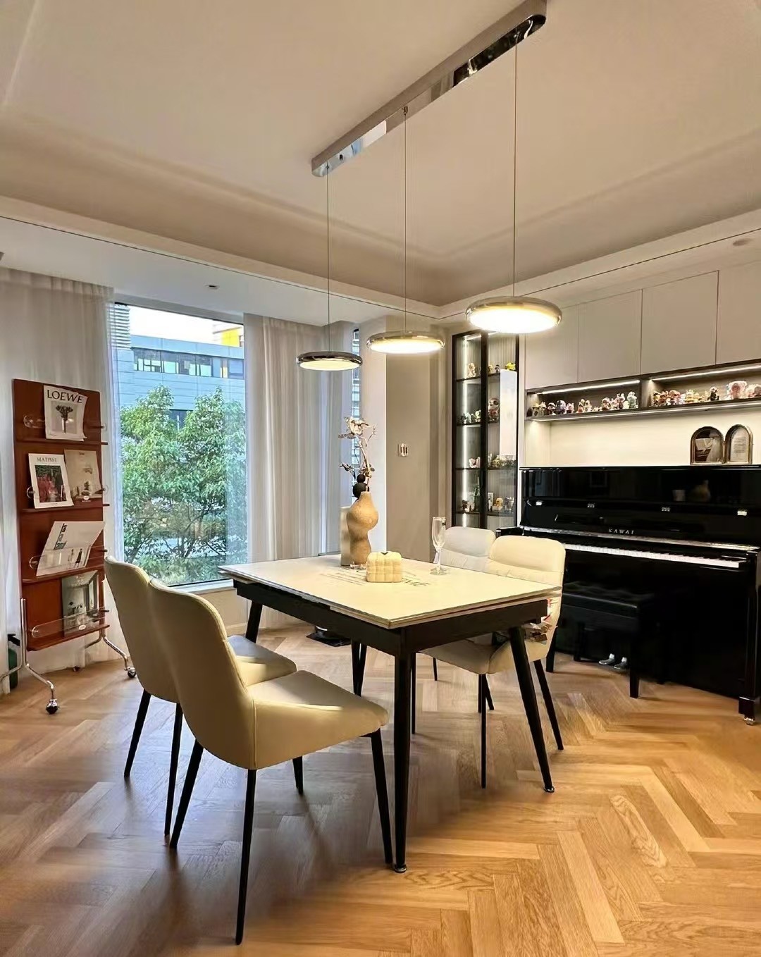 Wide herringbone engineered oak flooring installed in a modern eclectic apartment in Shanghai with open-plan interior design and natural lighting.