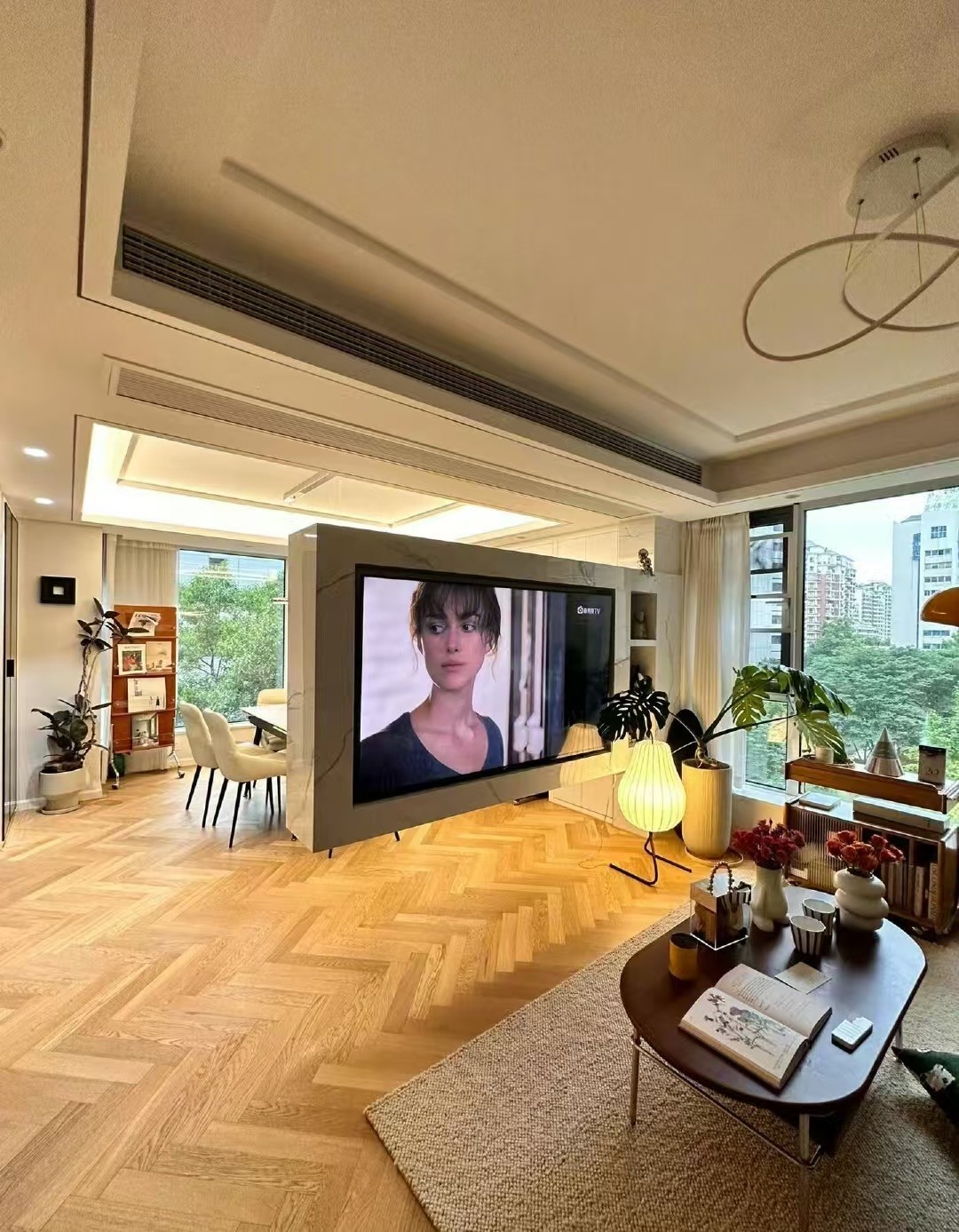 Wide herringbone engineered oak flooring installed in a modern eclectic apartment in Shanghai with open-plan interior design and natural lighting.