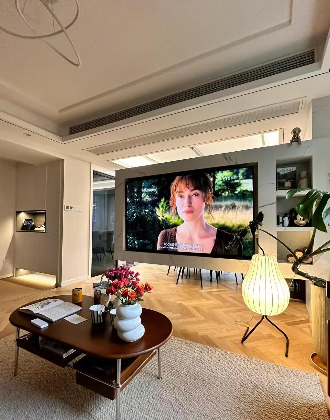 Wide herringbone engineered oak flooring installed in a modern eclectic apartment in Shanghai with open-plan interior design and natural lighting.