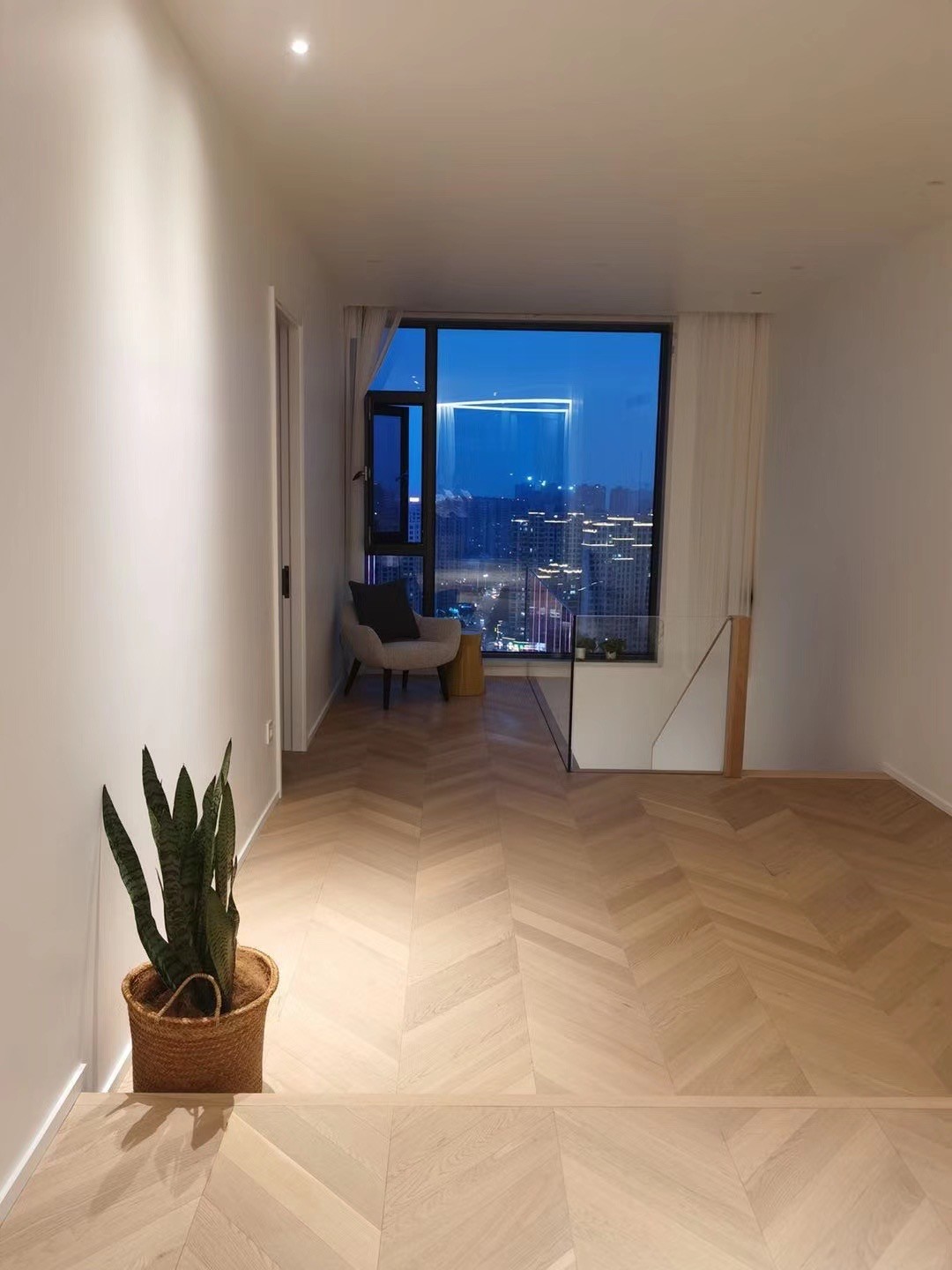 Engineered oak chevron flooring installed in a Scandinavian minimalist sky-loft in Copenhagen, Denmark, featuring raw light oak tone with brushed invisible finish