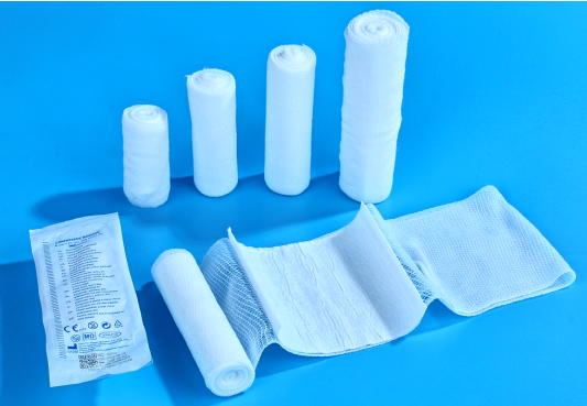 An assortment of bandages, sterile pads, and wipes from a DIN 13164 kit