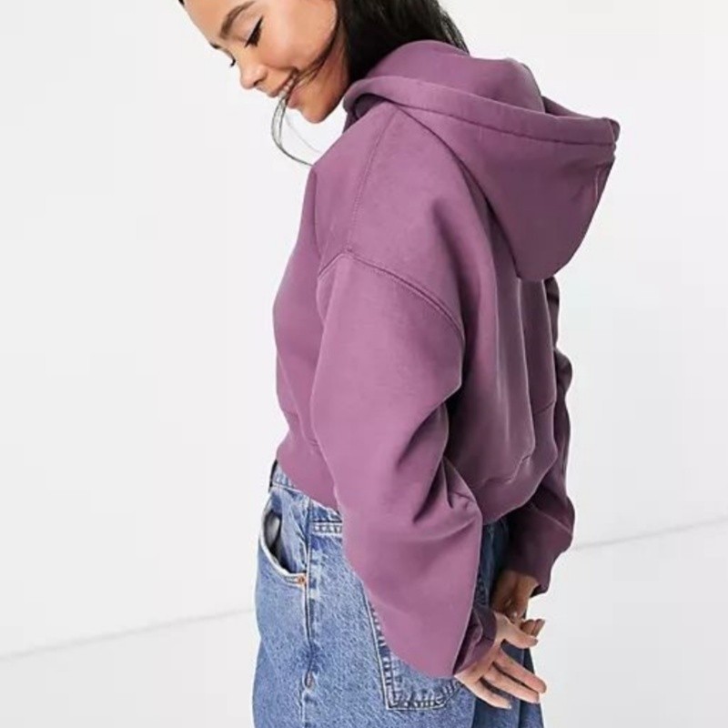 Caucasian model wearing a custom loopback hoodie: real wear result of french terry and brushed fleece in a growing brand's line