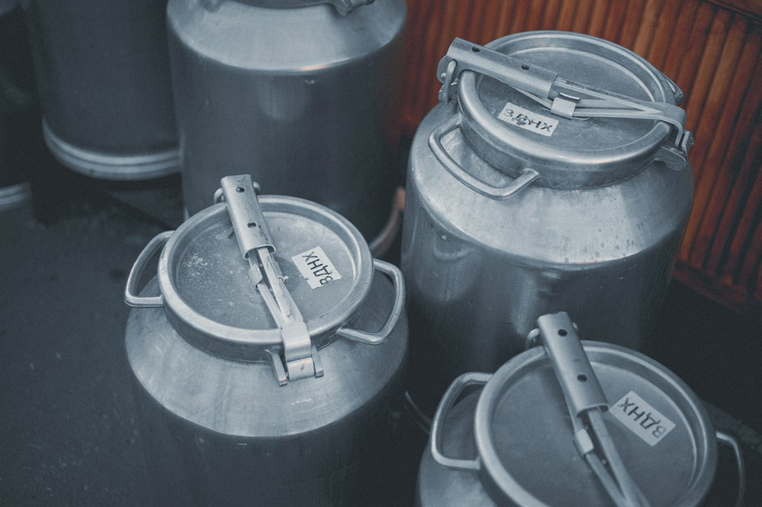 Different types of air compressor oils in containers