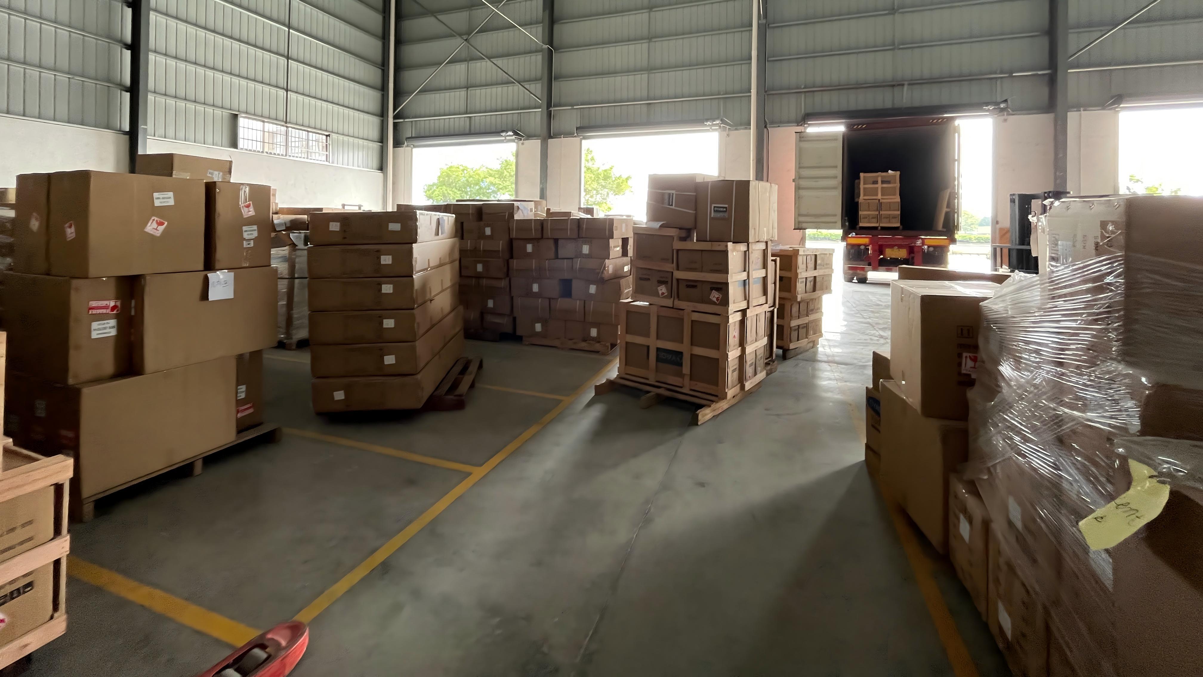 Warehouse shelving stocked with Oyaqua spare parts cartons