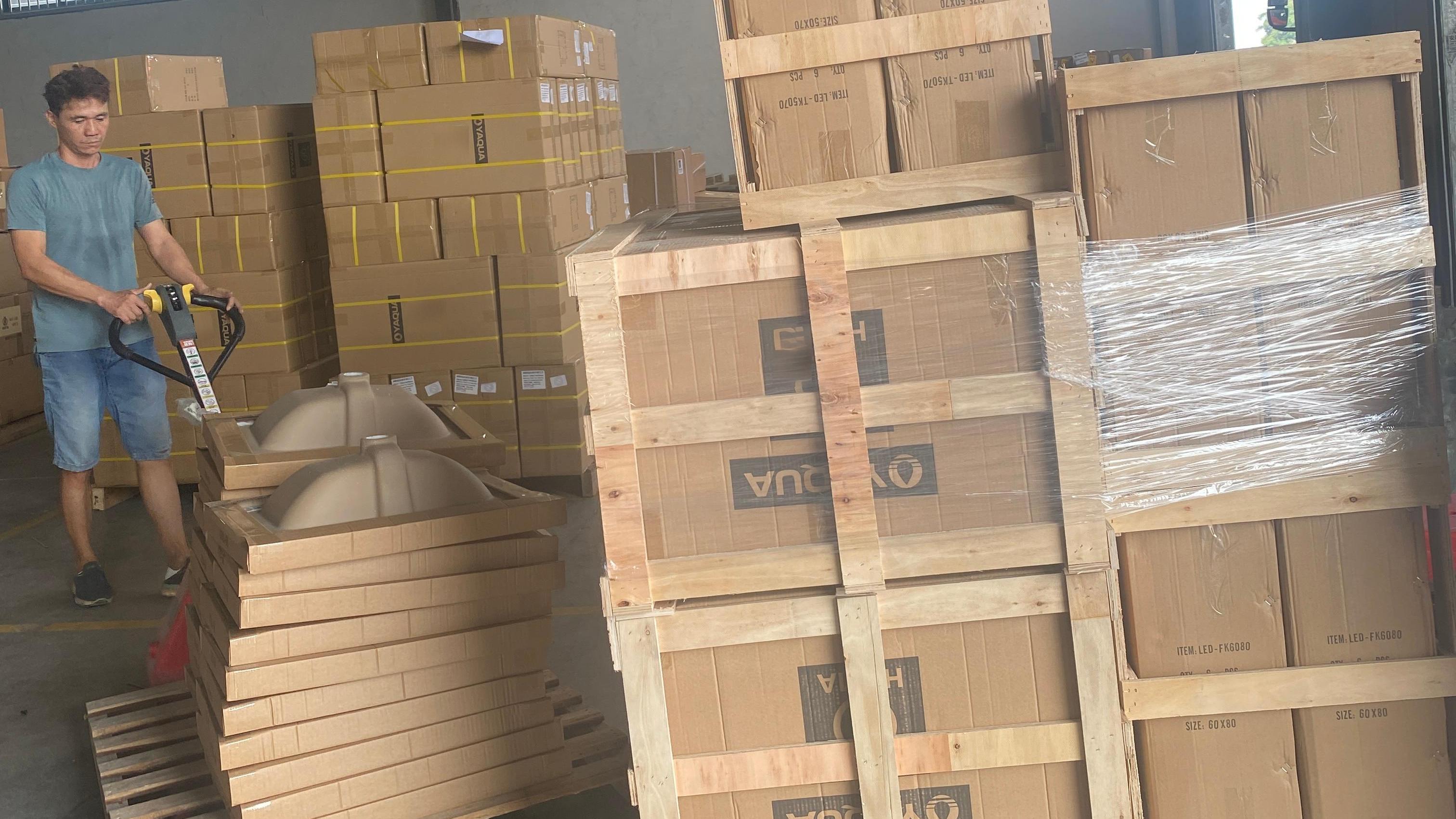Warehouse racking holding palletised cartons of bathroom mixers and shower sets in country