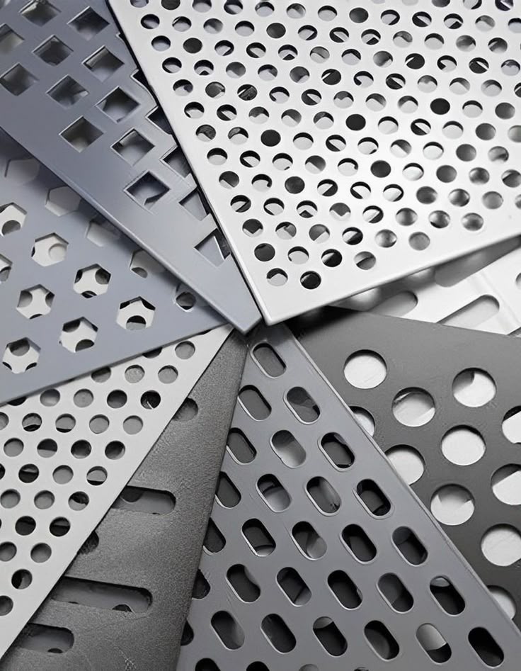 Fanned samples of perforated stainless steel showing round, square, hexagonal and slotted hole patterns