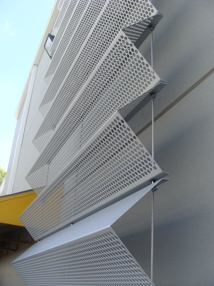Perforated stainless steel fins used as external sun-shading elements
