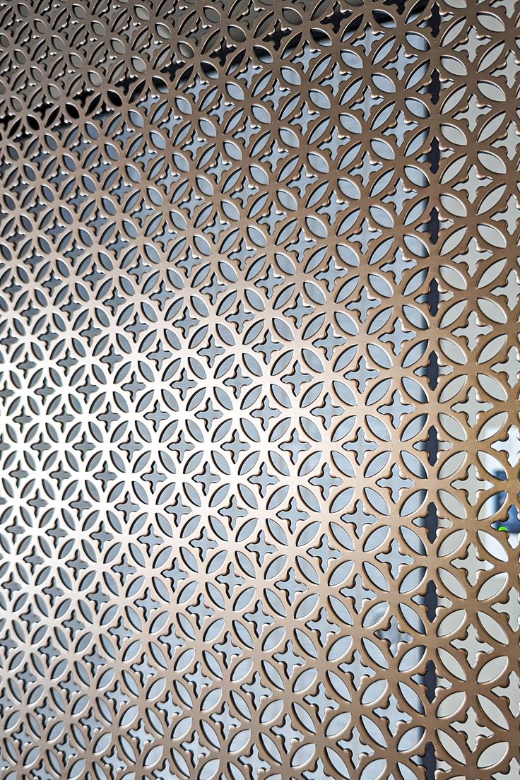 Decorative geometric perforated stainless steel screen for retail and hospitality interiors