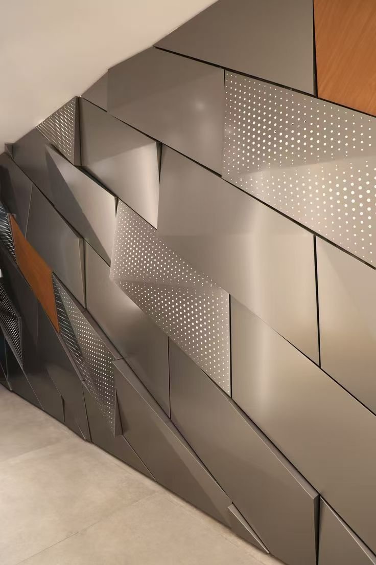 Close detail of a brushed stainless steel panel joint and corner return, showing material and workmanship