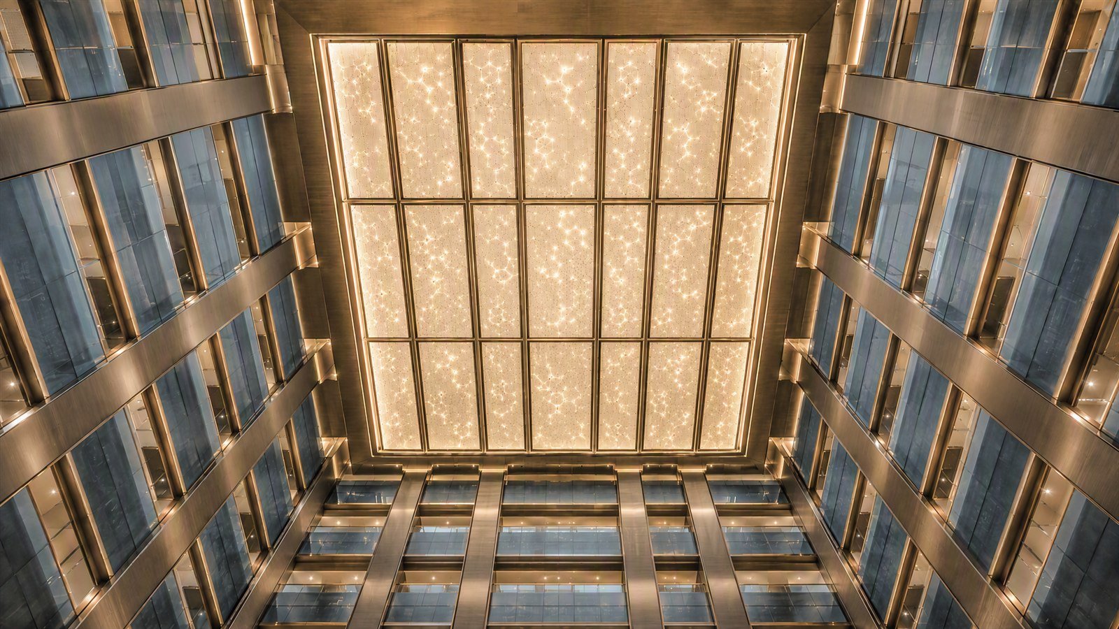 Lattice stainless steel ceiling with point lighting seen from below in a hotel lobby