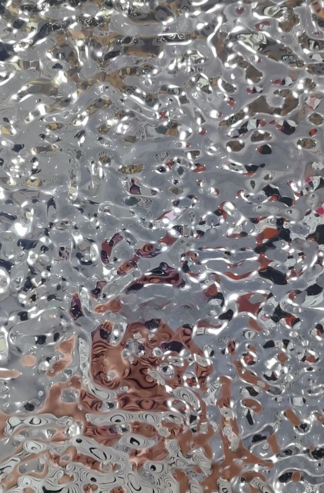 Water ripple stainless steel sample with fluid formed reflections