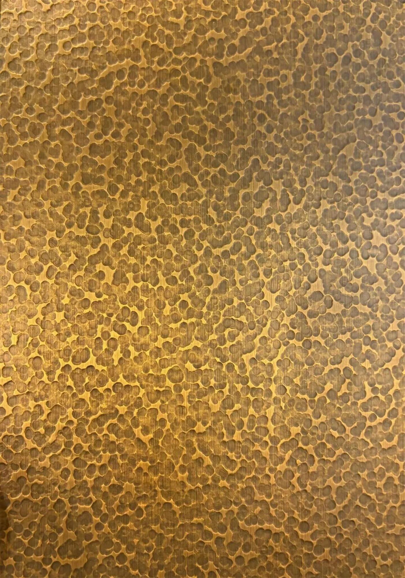 Hammered stainless steel sample with irregular handcrafted textured depth
