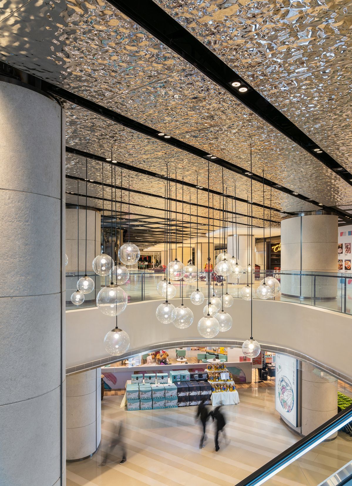 Mirror ripple stainless steel ceiling over a luxury shopping mall atrium
