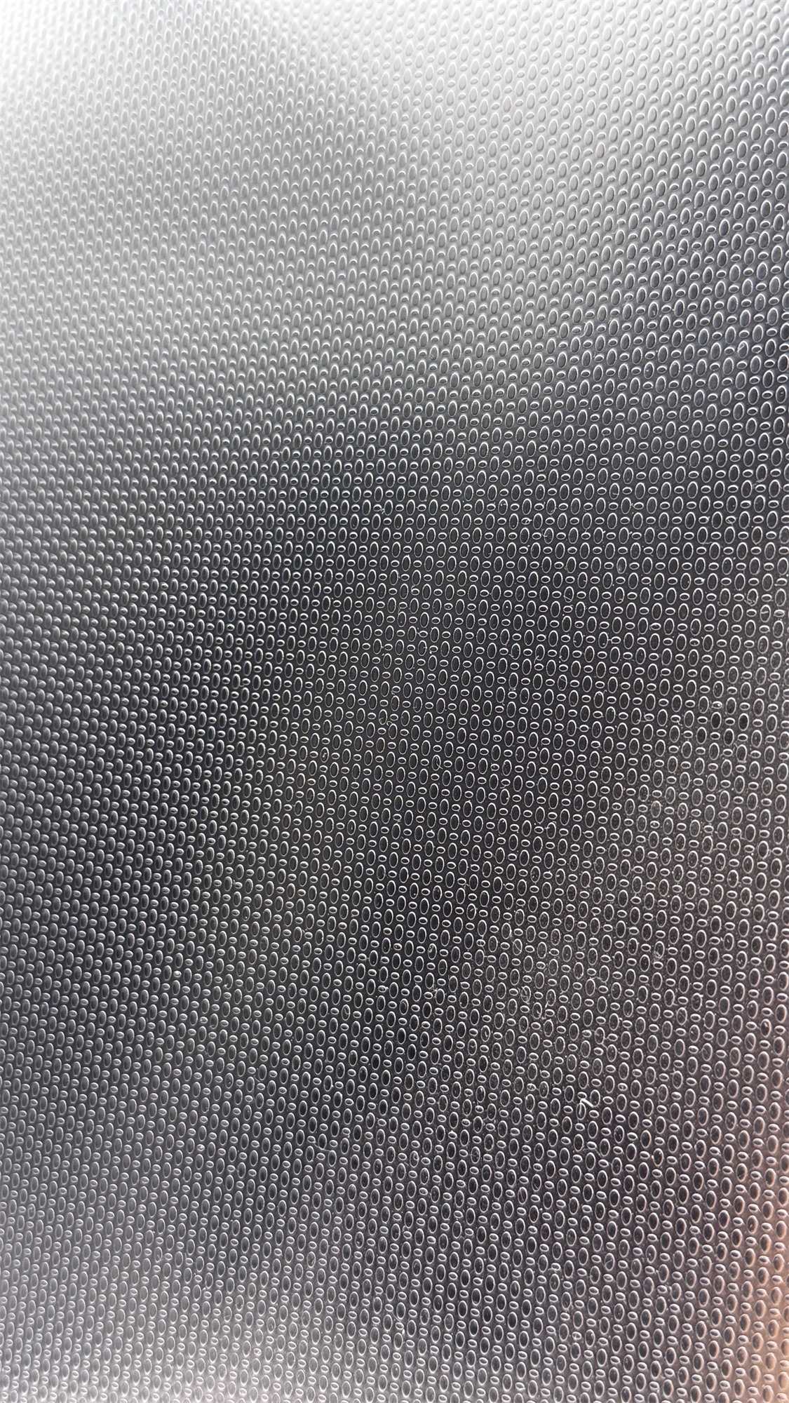 Custom embossed stainless steel sample plate with a fine oval relief pattern
