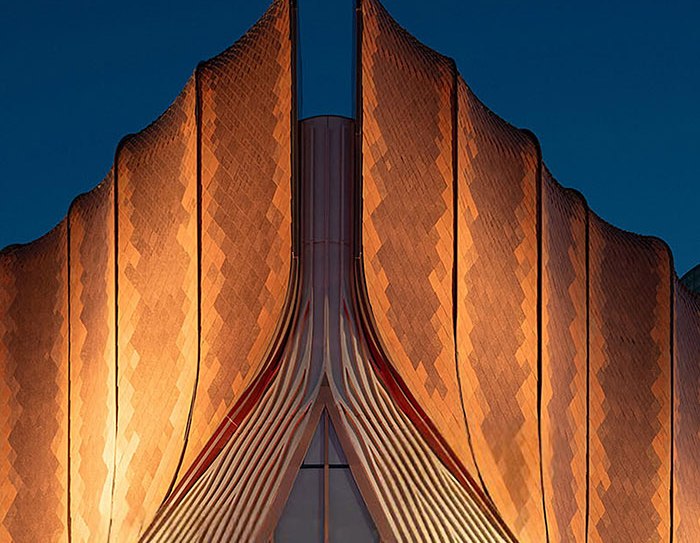 Pleated stainless steel facade carrying a chevron relief pattern