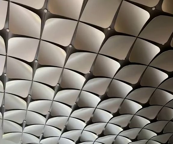 Formed stainless steel soffit panels with a repeating relief pattern installed overhead