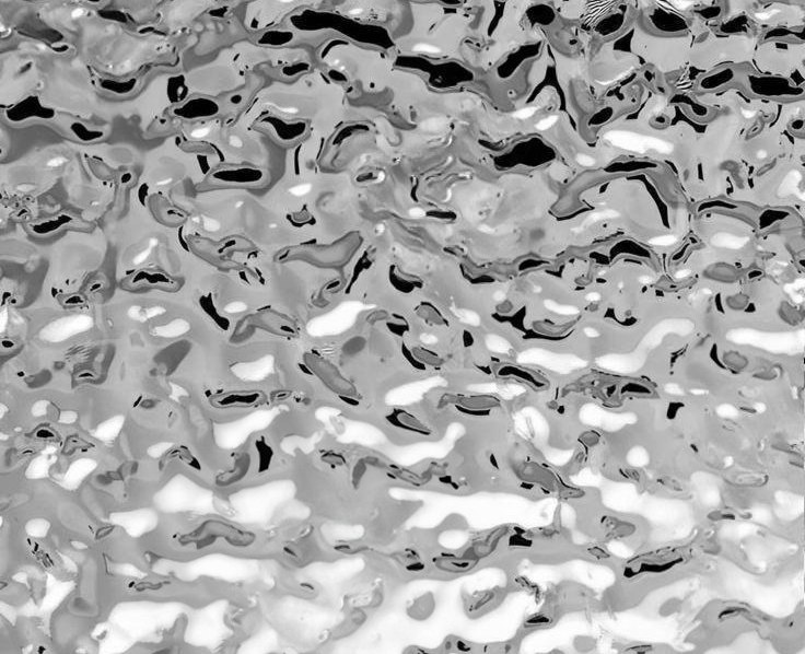 Water ripple stainless steel surface showing the irregular embossed relief and reflected highlights