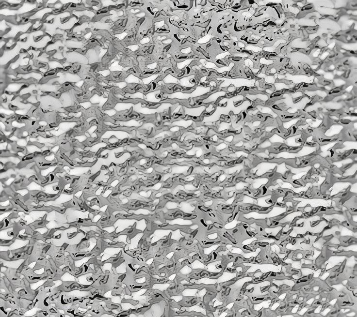 Water ripple stainless steel under soft even light with quiet tonal transitions