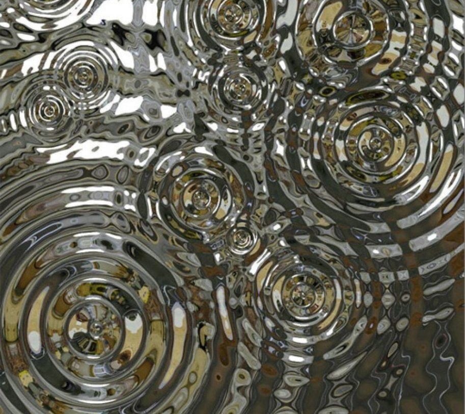 Water ripple stainless steel under directional light with strong contrast between highlights and valleys