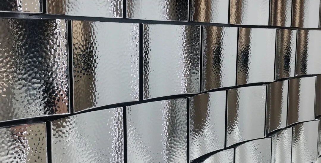 Water ripple stainless steel shingle cladding formed as a bespoke curved surface