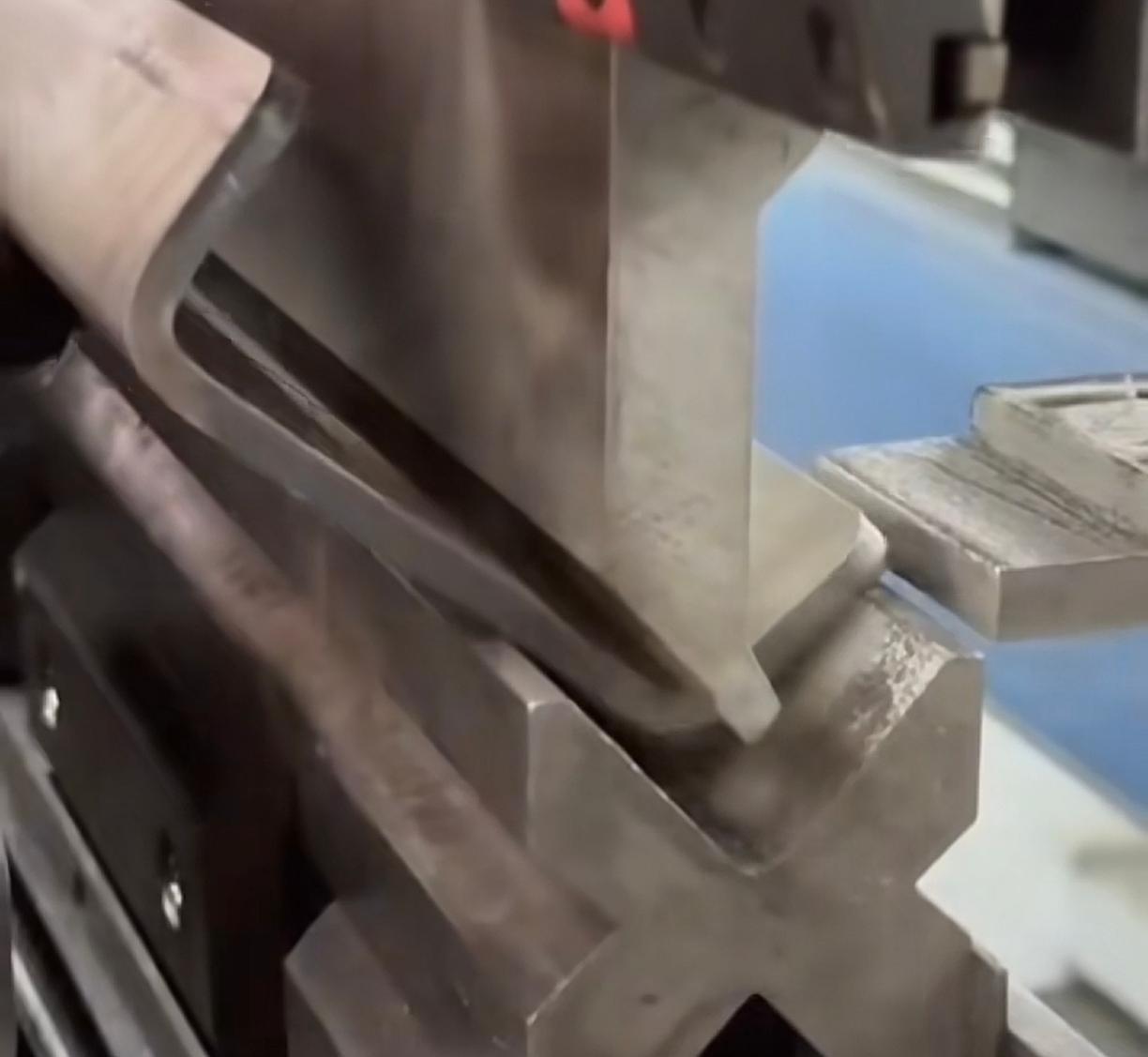 Water ripple stainless steel being bent on a press brake to a project return