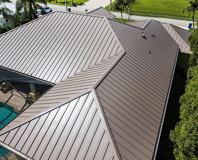 Folded stainless steel roof panels meeting at a ridge with expressed joints