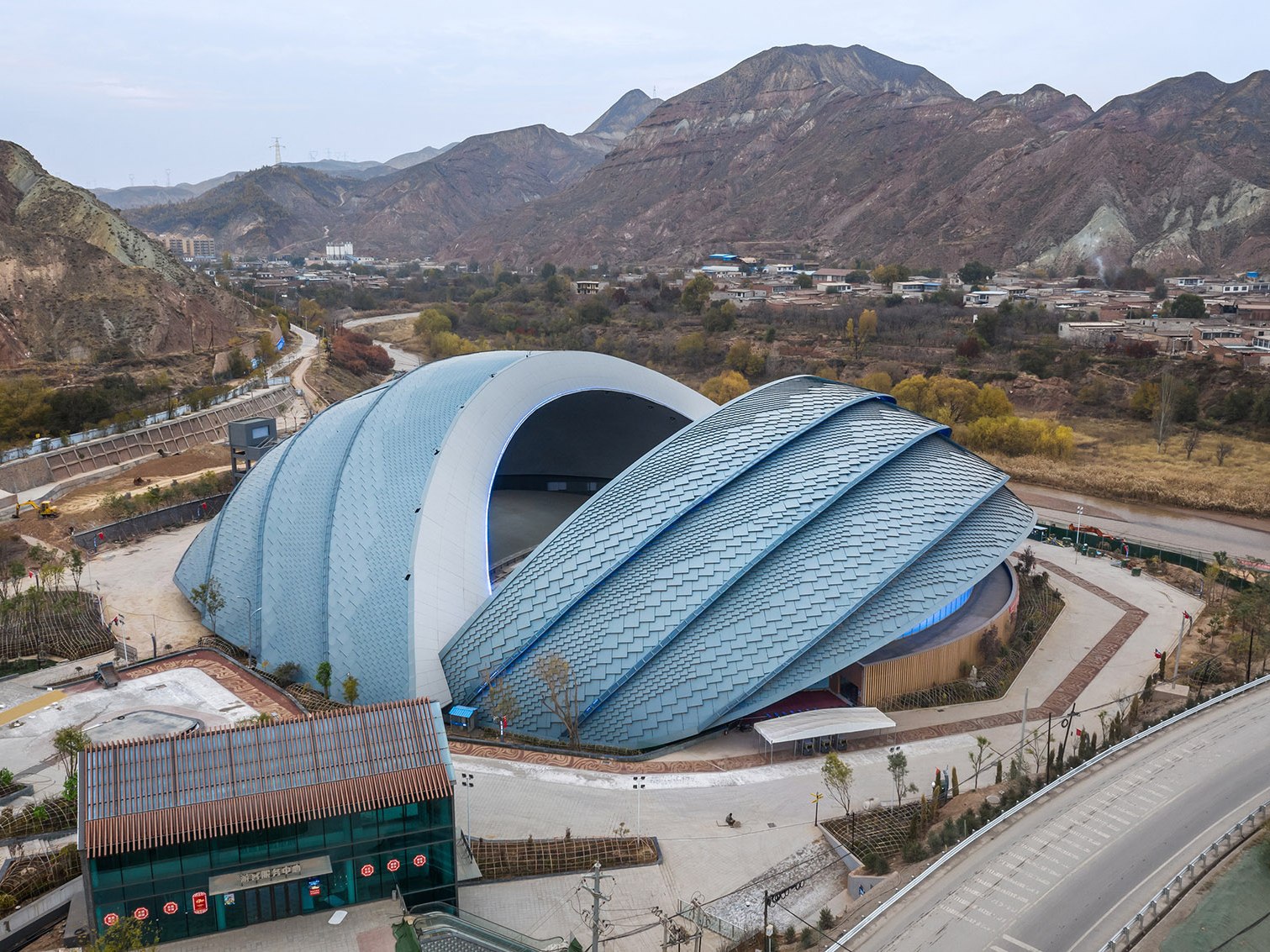 Sculptural folded stainless steel roof of a cultural exhibition building