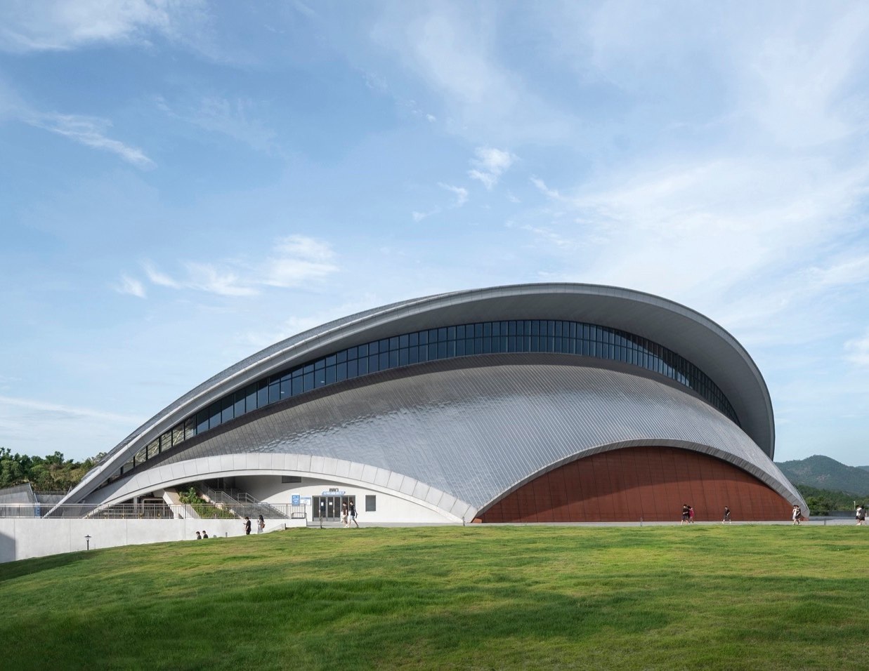 Curved stainless steel roof over a large public events building