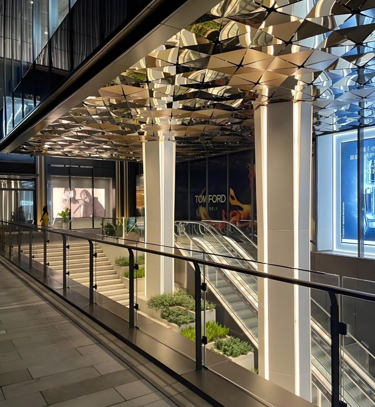 Continuous canopy soffit running along a colonnade of clad columns