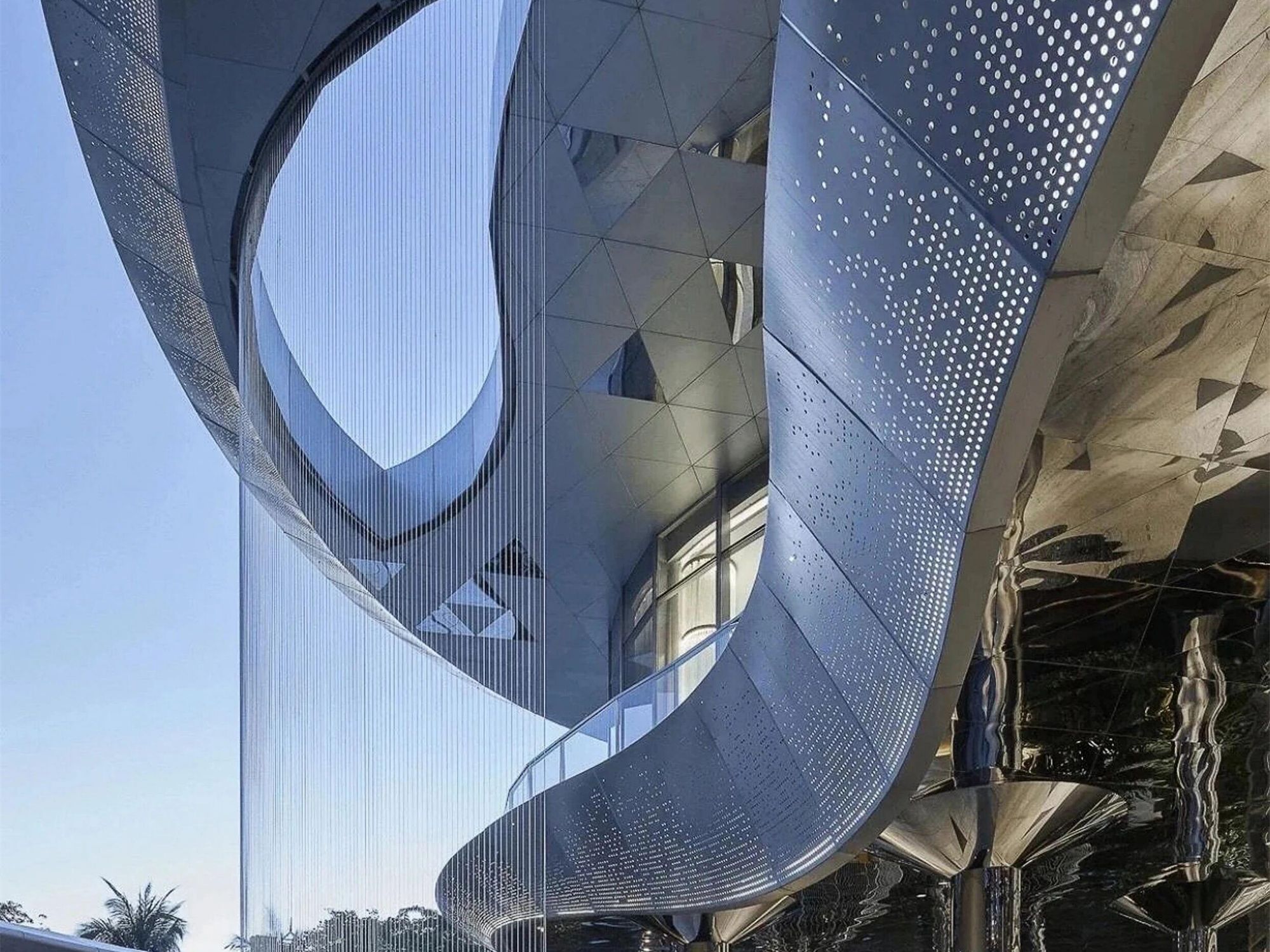 Mirror finish curved stainless steel entrance canopy reflecting its surroundings