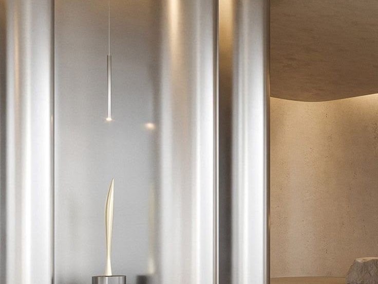 Large curved stainless steel wall cladding forming a continuous interior plane
