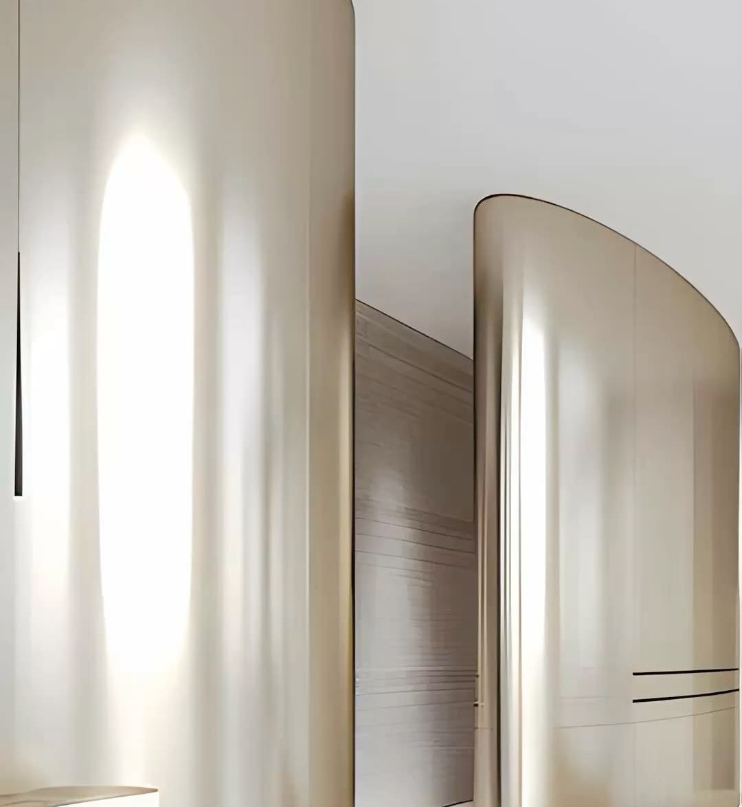 Continuous mirror finished stainless steel wall plane in a bright interior