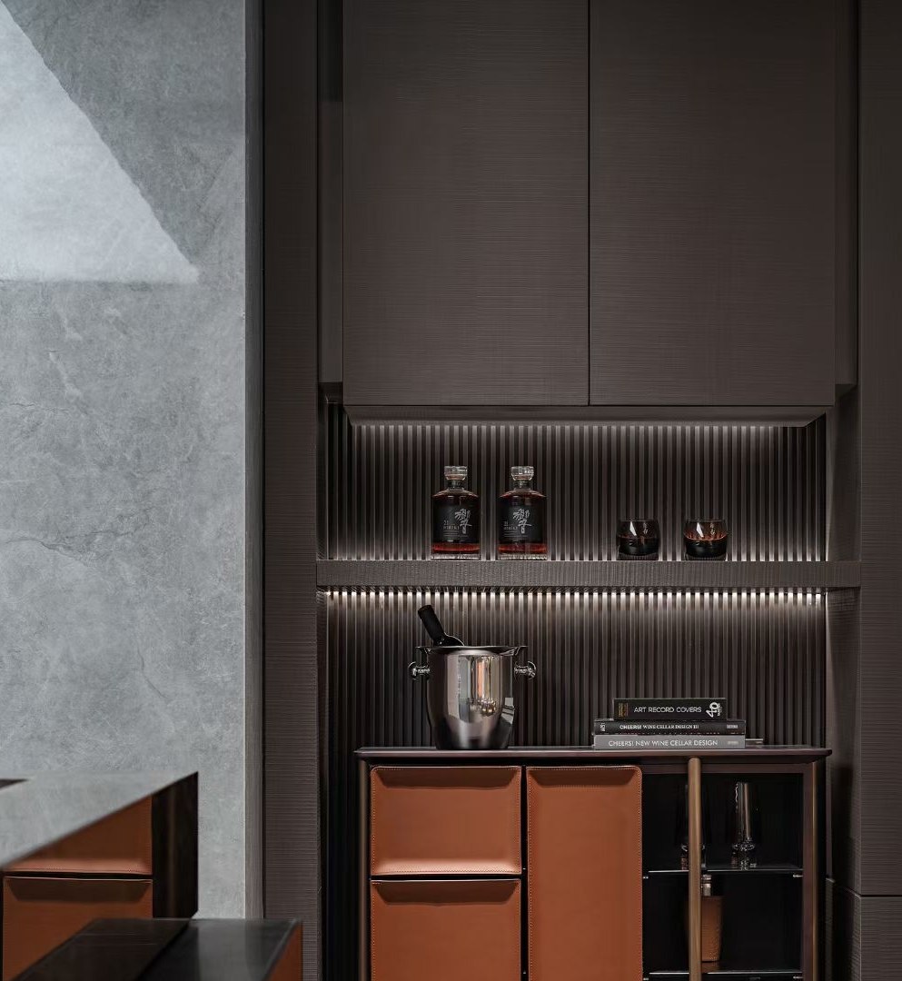 Stainless steel cladding meeting stone and timber surfaces in one detail