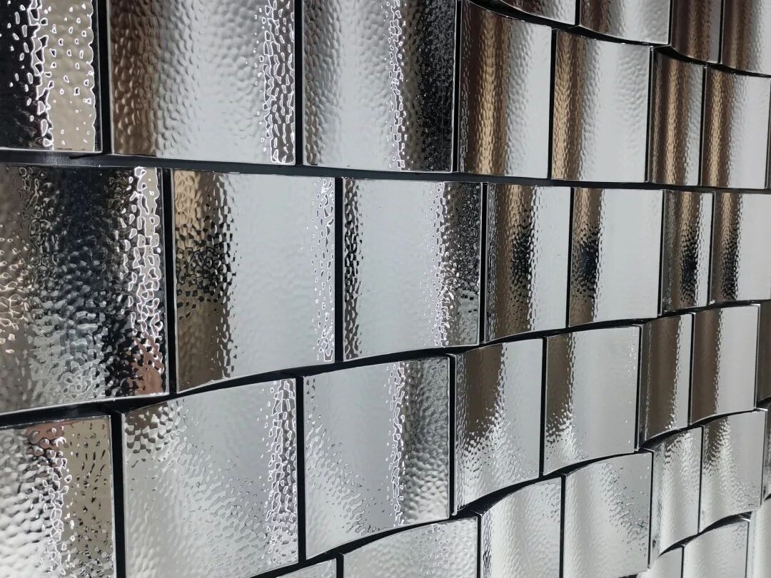 Water ripple embossed stainless steel feature wall catching reflected light