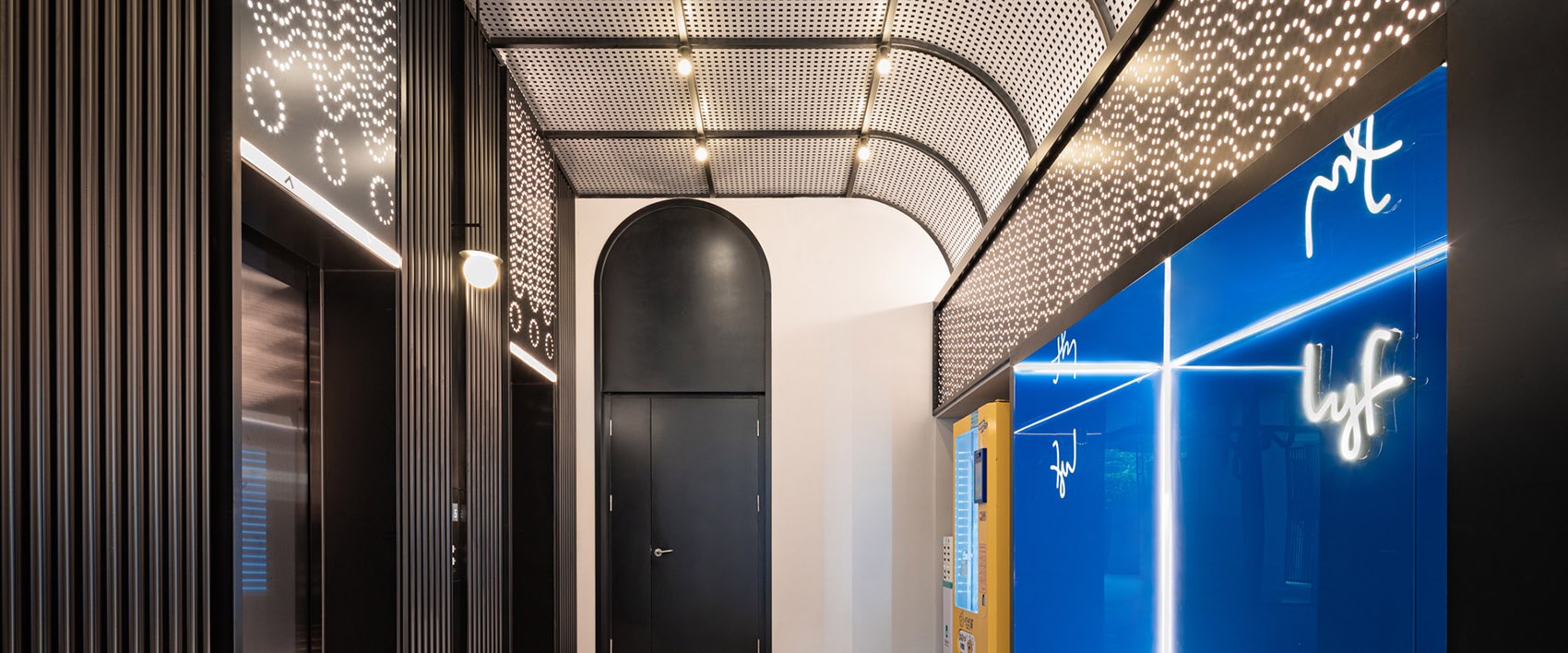 Stainless steel elevator lobby surfaces under architectural lighting