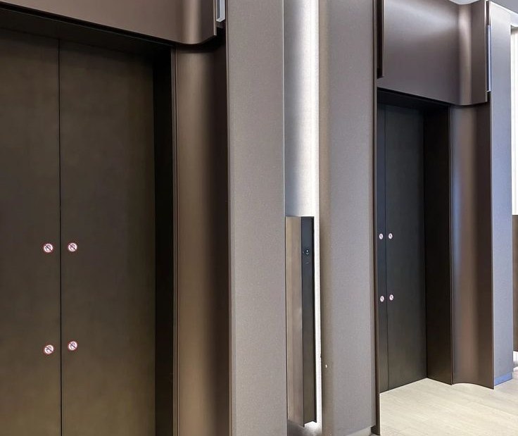 Portal corner where stainless steel cladding turns into the elevator surround