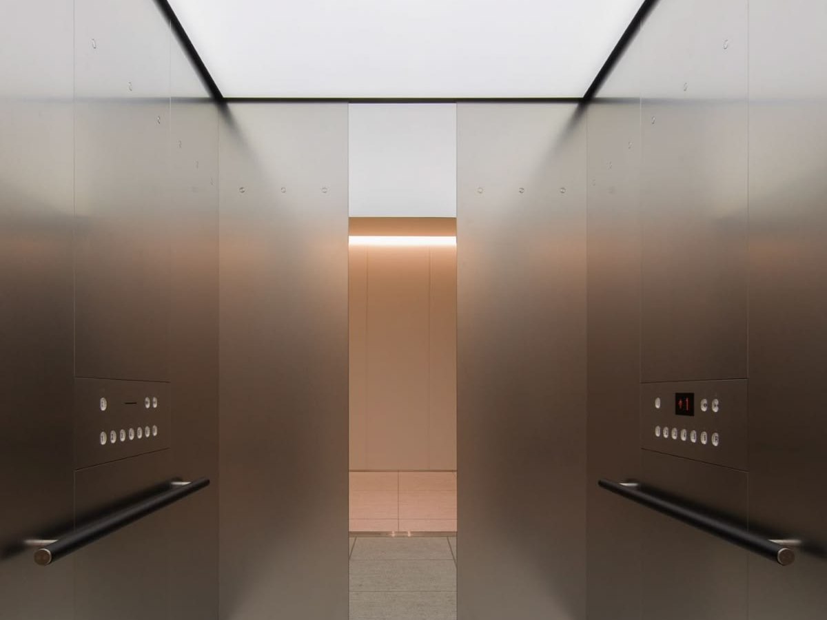 Brushed stainless steel cabin walls with restrained reflection