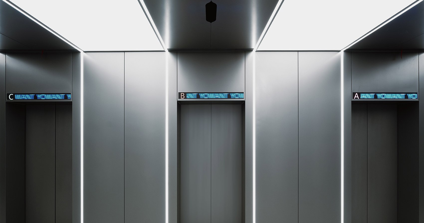 Elevator lobby and cabin sequence sharing one stainless steel palette