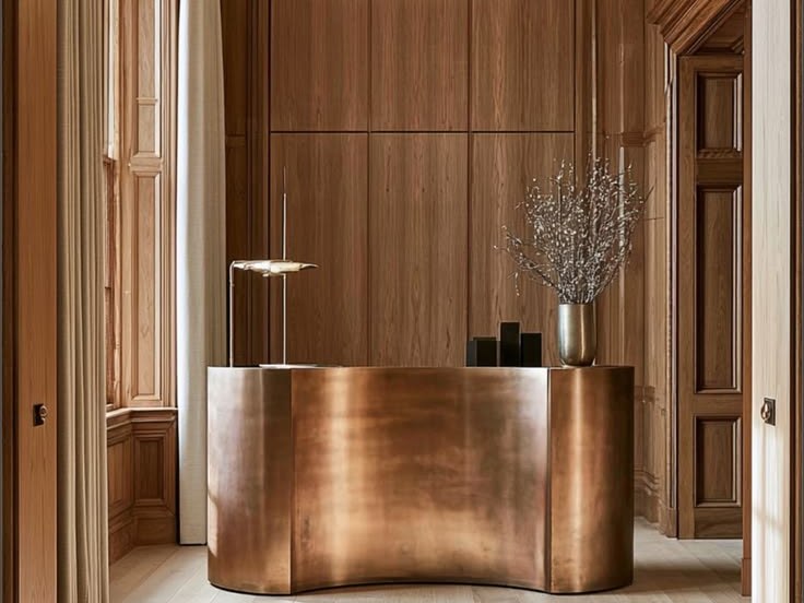 Hammered bronze stainless steel reception and bar counter against a timber wall