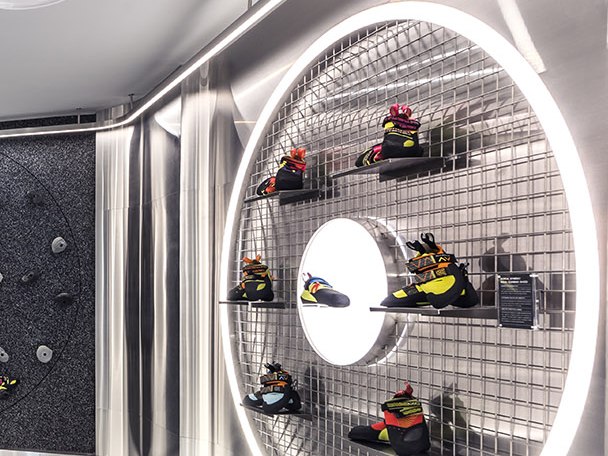 Precision-fabricated stainless steel mesh display niche with illuminated shelving for luxury retail