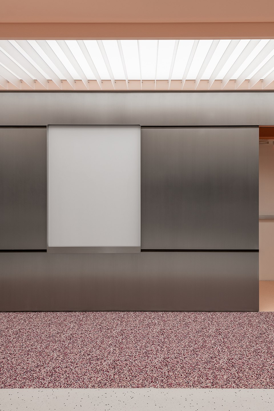Quiet continuous brushed stainless steel wall surface for close-range interiors
