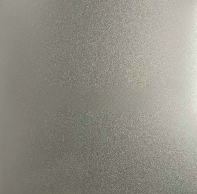 Bead-blasted stainless steel under interior lighting, showing soft highlights instead of sharp reflections