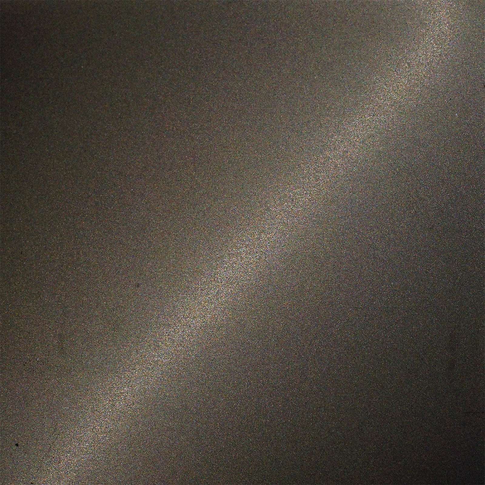 Dark matte bead-blasted stainless steel surface under soft directional light