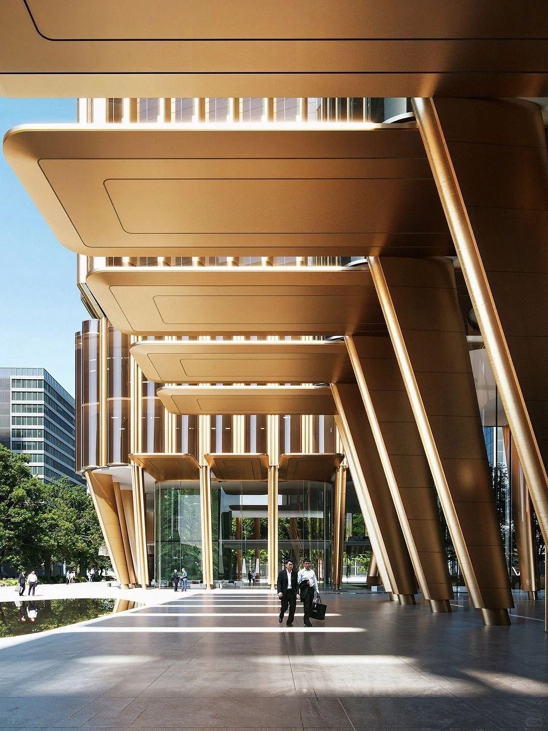 Warm metallic entrance portal clad in champagne-toned PVD stainless steel